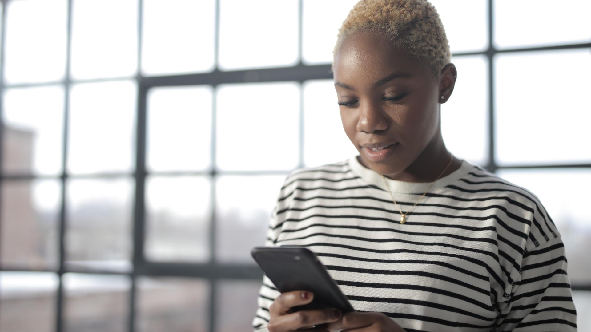 photo of woman checking her phone